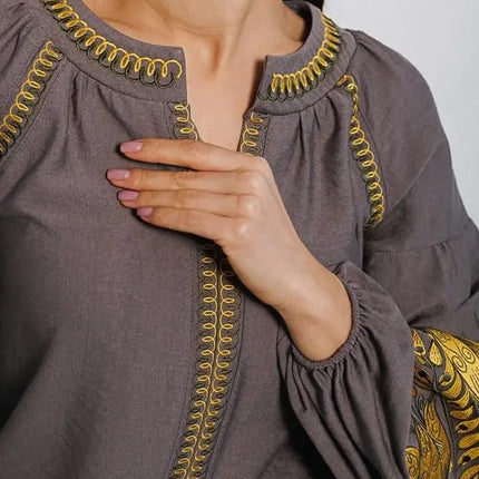 Women's embroidered blouse in graphite color with smooth floral patterns on the sleeves