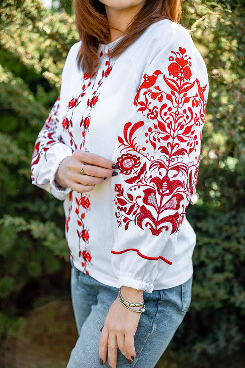 Women's embroidered shirt with a blooming ornament